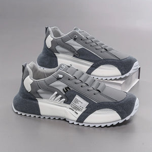 Gray and white sneakers on a gray background