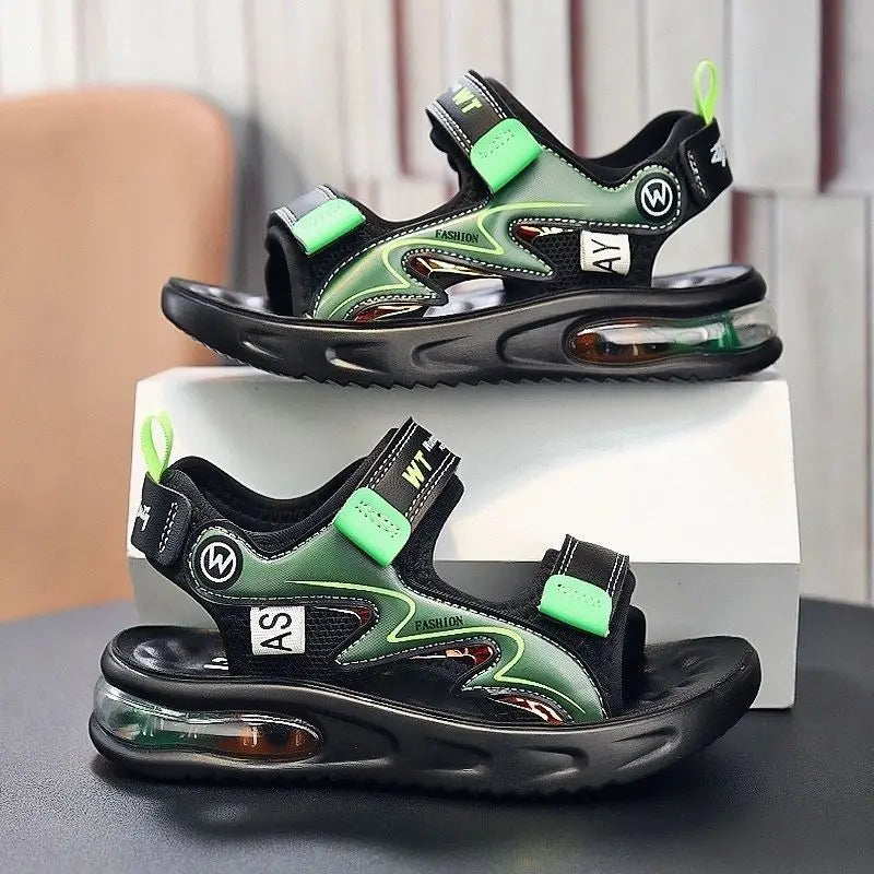 Black and green sandals with air cushion sole on a gray surface