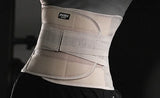 Beige waist support brace worn by a person on a black background