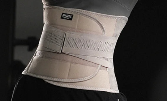 Beige waist support brace worn by a person on a black background