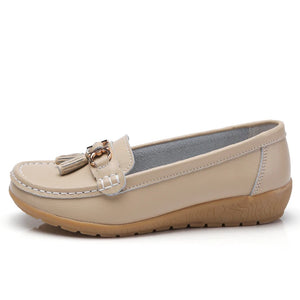 Women's leather loafers with metal tassel detail, round toe, and rubber sole