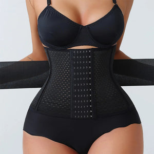 Black waist trainer worn by a person on a light gray background