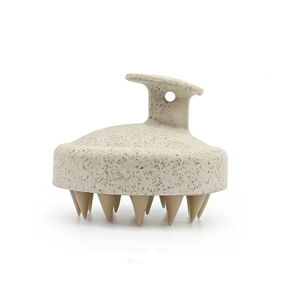 Beige scalp massager with textured surface on a white background