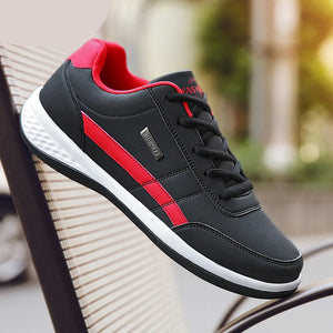 Black and red sneaker with 'MAEDEF' branding on a blurred outdoor background