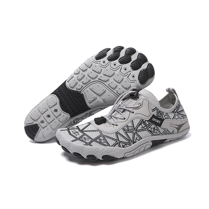 Pair of gray athletic shoes with black pattern on a white background