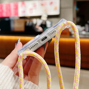 Shockproof Magnetic Clear iPhone Case with Hanging Rope with colorful strap held by a hand in a blurred indoor setting