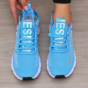 Blue running shoes with white accents on a wooden floor