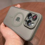 Person holding a Matte translucent magnetic iPhone case with camera lens protection and MagSafe on a wooden surface
