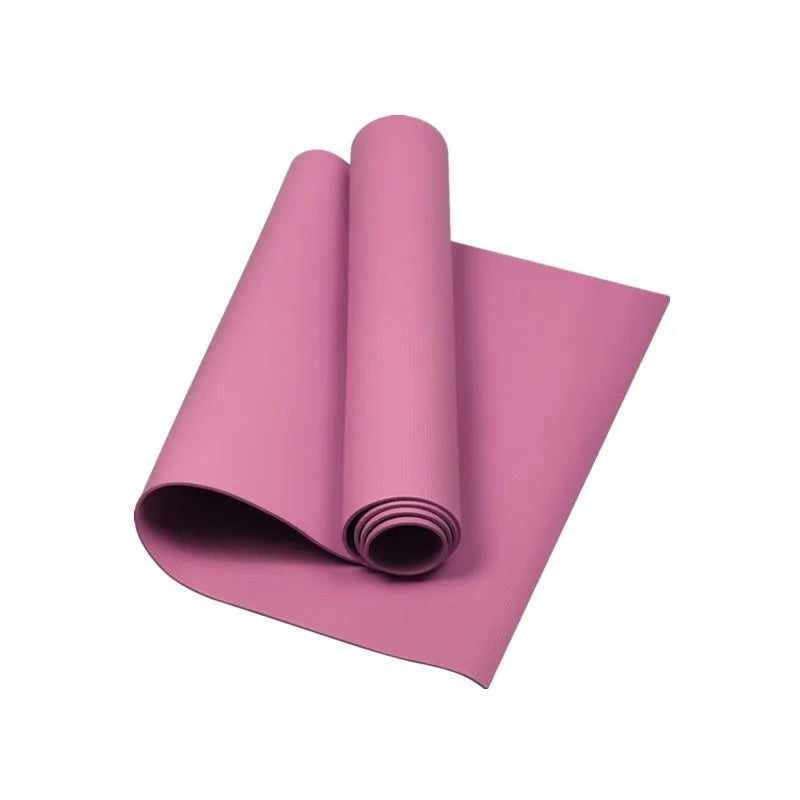 Pink yoga mat rolled up on a white background
