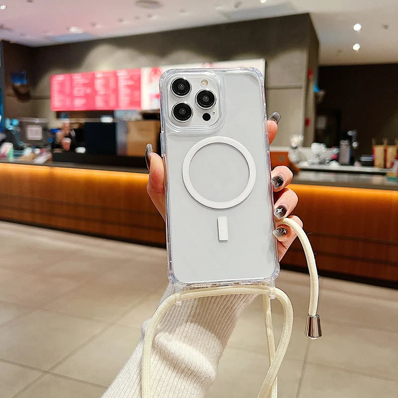 Person holding a phone with a clear case featuring a magnetic charging pad in a blurred indoor setting.