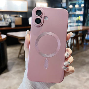 Pink phone case with a metallic design held by a hand in a blurred indoor setting