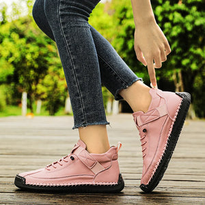 Pink Slip-On Shoes worn with dark jeans on a wooden floor with greenery in the background