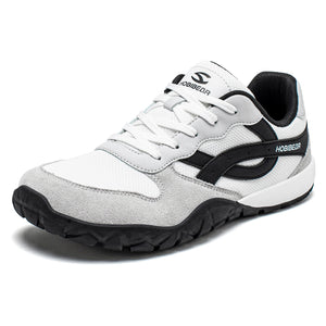 White and gray sneaker with black accents on a white background