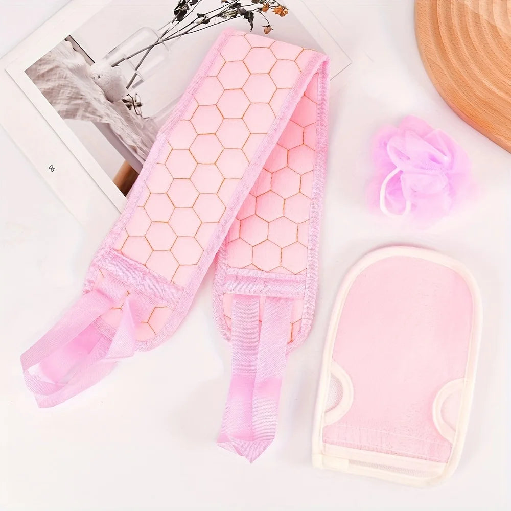 Pink honeycomb-patterned gloves on a white surface with a blurred background
