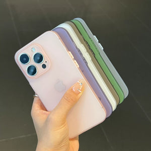 Stack of phone cases in various colors held by a hand on a dark background