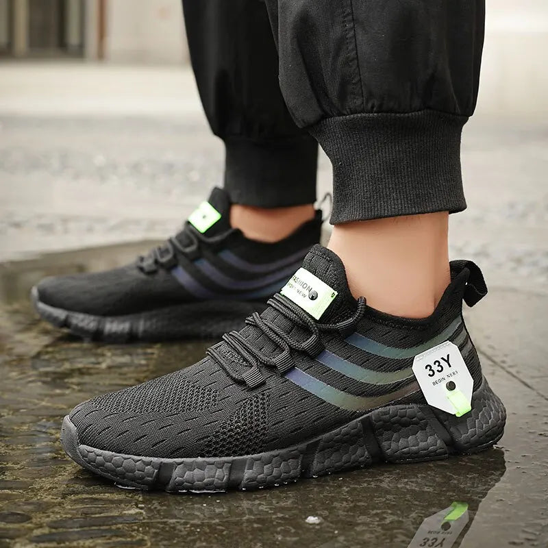 Black athletic shoes with a brand tag on a concrete surface