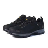 A pair of black outdoor hiking shoes with gray soles and small yellow accents, shown on a white background.