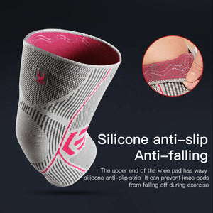 Gray and pink knee pad with silicone anti-slip feature on a dark background