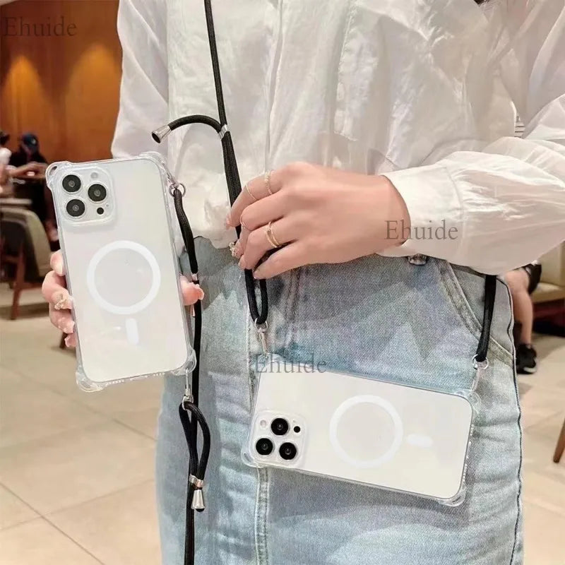Person holding a clear iphone case with a strap, wearing a white shirt and blue jeans.