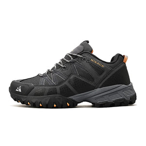 Black hiking shoe with orange accents on a white background.