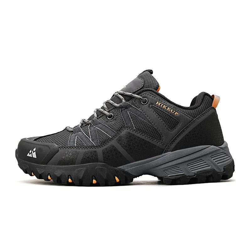 Black hiking shoe with orange accents on a white background.