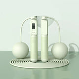 White jump rope with digital display on a light gray background, labeled 'Dual purpose' and 'Green'.