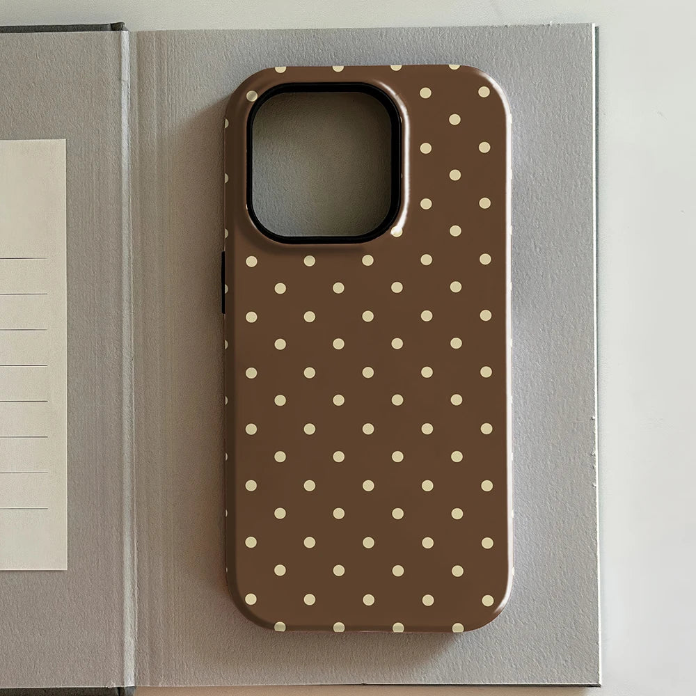 iPhone case with polka dot pattern on a gray surface