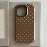 iPhone case with polka dot pattern on a gray surface