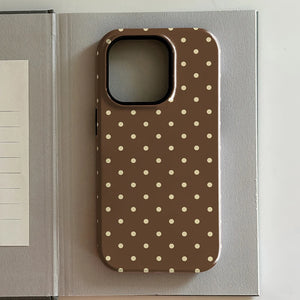 iPhone case with polka dot pattern on a gray surface