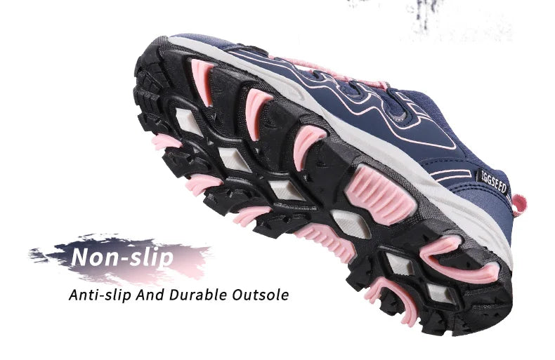 A single athletic shoe shown from the side on a white background, with text overlays reading 'Non-slip' and 'Anti-slip And Durable Outsole'. The shoe has a navy blue upper, white midsole, and pink and black outsole.