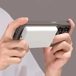 Person holding a Matte magnetic iPhone case compatible with Magsafe wireless charging with a white card in front of the camera lens on a gray background