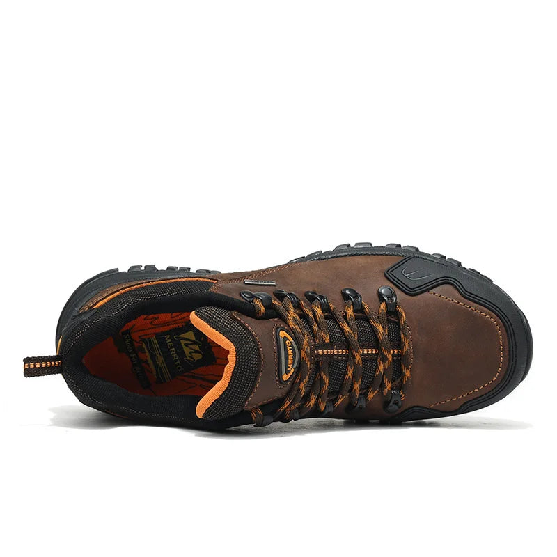 Brown hiking boot with orange accents on a white background