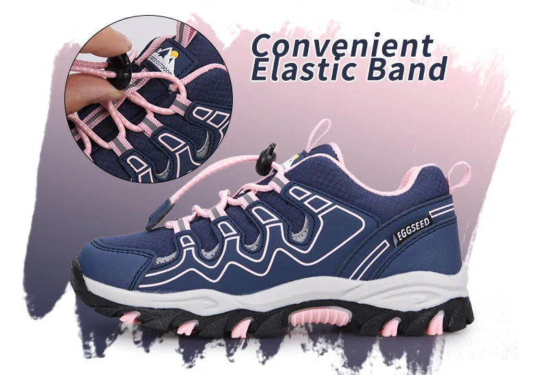A navy blue athletic sneaker with pink laces and pink accents, shown on a white and pink graphic background. A circular inset highlights the elastic lacing system, and the text reads 'Convenient Elastic Band.