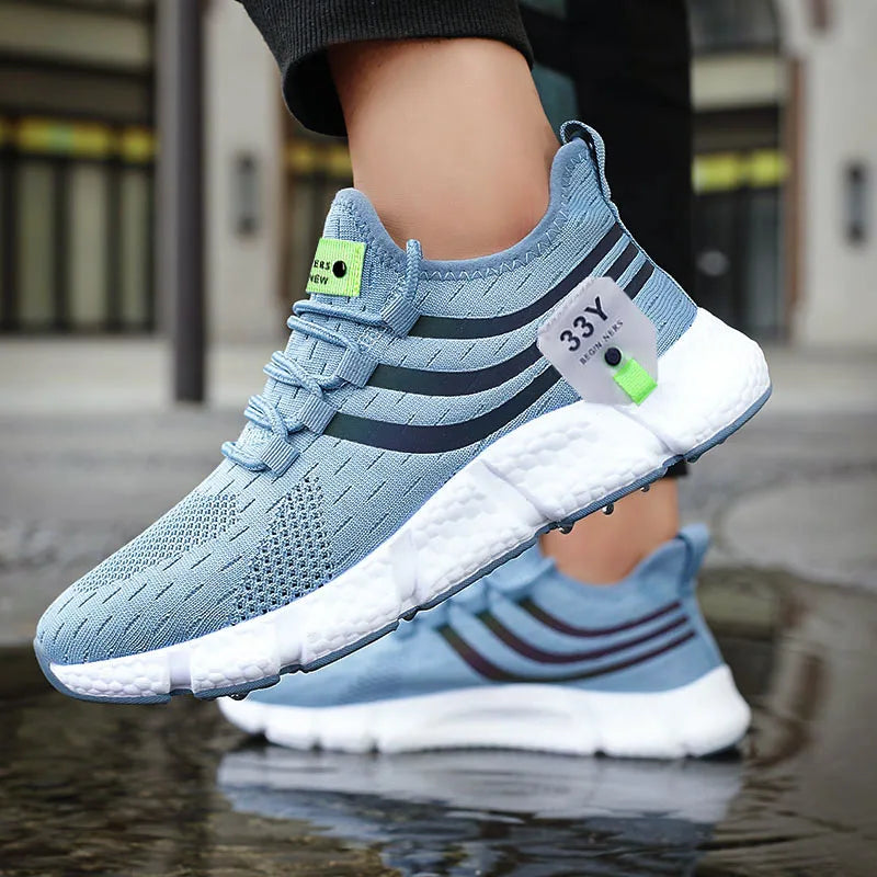 Blue athletic shoes with white soles on a reflective surface