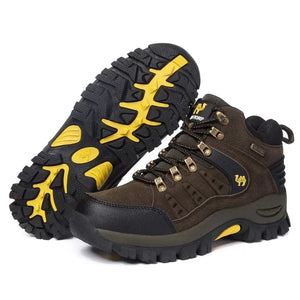 Pair of brown hiking boots with yellow accents on a white background