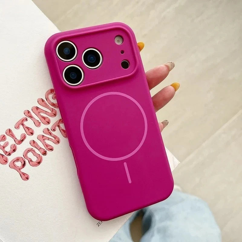 Pink phone case held by a hand with a light background