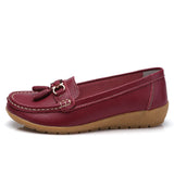 Women's leather loafers with metal tassel detail, round toe, and rubber sole