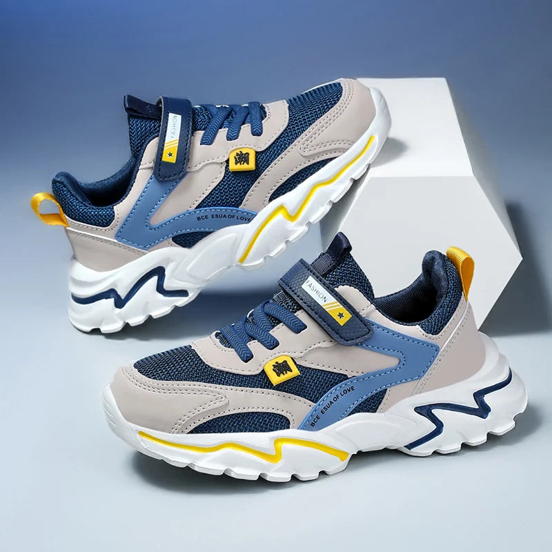 Pair of blue and gray sneakers with yellow accents on a light gray background
