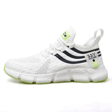 White sneaker with black stripes and green accents on a white background