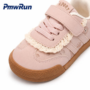 A pink children's low-top sneaker by PmwRun, featuring a hook-and-loop strap, lace-up closure, decorative lace trim, and a brown rubber sole, shown on a white background.