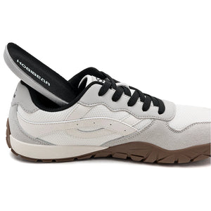 A white and light gray athletic shoe with black laces, a black interior lining, and a brown outsole, shown in a side profile on a white background.