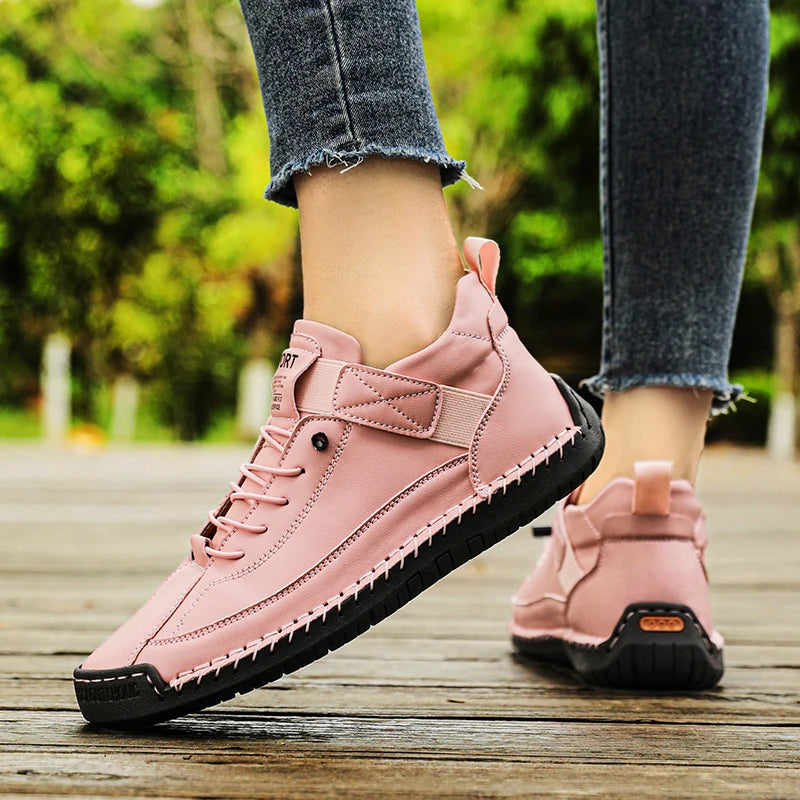 Pink Slip-On Shoes with black soles worn by a person on a wooden floor with a blurred green outdoor background.