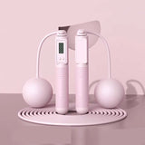 Pink jump rope with digital display on a pink background, labeled 'Dual purpose' and 'Pink'.