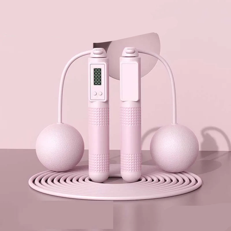 Pink jump rope with digital display on a pink background, labeled 'Dual purpose' and 'Pink'.