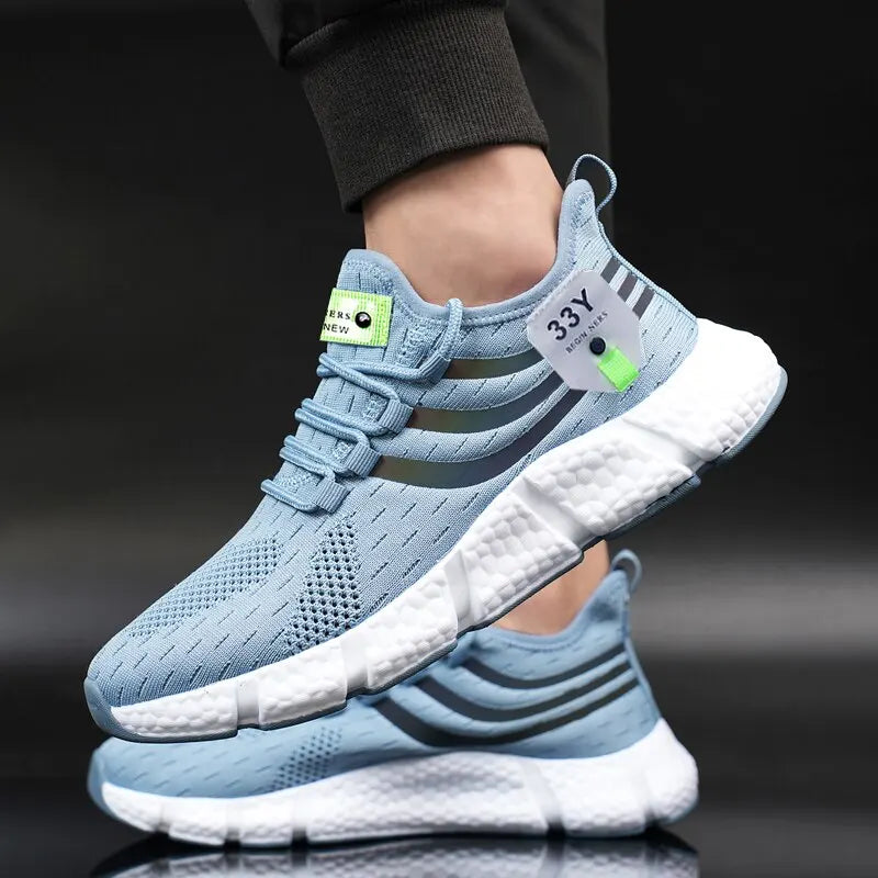A light blue athletic sneaker with a white cushioned sole, shown being worn with the other shoe placed below it on a dark reflective surface.