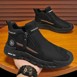 Black boots with a zipper held by a hand on a wooden surface