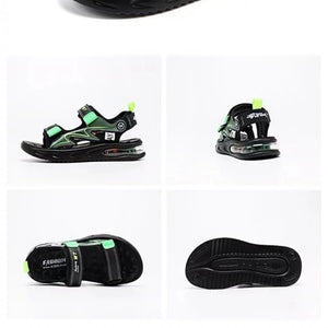 Black children's sandals with green accents on a white background