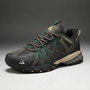 Dark gray hiking shoe with green accents on a gray background