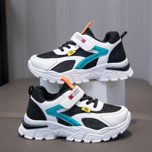 Pair of children's athletic shoes with colorful accents on a gray background