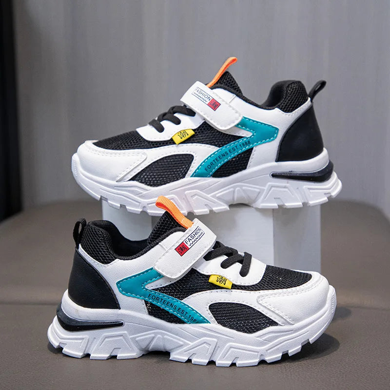 Pair of children's athletic shoes with colorful accents on a gray background